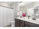 Bathroom featuring a double vanity, shower with curtain, and coordinated towel racks at 562 Boulder Point Dr, Chapel Hill, NC 27516
