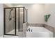 Contemporary bathroom with a glass-enclosed shower and a soaking tub with tile surround at 562 Boulder Point Dr, Chapel Hill, NC 27516