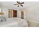 Bedroom featuring a ceiling fan and barn-style door leading to the bathroom at 562 Boulder Point Dr, Chapel Hill, NC 27516