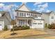 Charming two-story home featuring a welcoming front porch, two-car garage, and well-manicured lawn at 562 Boulder Point Dr, Chapel Hill, NC 27516