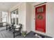 Inviting front porch with a red door, rocking chairs and a black painted floor at 562 Boulder Point Dr, Chapel Hill, NC 27516