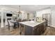 Open concept kitchen with large island and stainless steel appliances, view into the dining room at 562 Boulder Point Dr, Chapel Hill, NC 27516