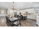 Spacious kitchen with an island, white cabinetry, and an adjacent dining area at 562 Boulder Point Dr, Chapel Hill, NC 27516