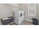 Laundry room with washer, dryer, wire shelving and natural light from the window at 562 Boulder Point Dr, Chapel Hill, NC 27516
