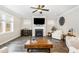 Inviting living room with a fireplace, TV, and wood-look floors at 562 Boulder Point Dr, Chapel Hill, NC 27516