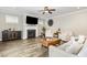 Bright living room with hardwood floors, fireplace, ceiling fan, and view to the outdoors at 562 Boulder Point Dr, Chapel Hill, NC 27516
