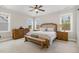 Spacious main bedroom with three windows, neutral paint, and a king bed at 562 Boulder Point Dr, Chapel Hill, NC 27516