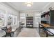 Bright home office with large windows and custom desk, bookshelves, and rug at 562 Boulder Point Dr, Chapel Hill, NC 27516
