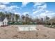 Community pool featuring brick pavers, cabanas, lounge chairs, and trees in the background at 562 Boulder Point Dr, Chapel Hill, NC 27516