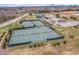 Aerial view of well maintained community tennis courts with parking and other amenities visible at 562 Boulder Point Dr, Chapel Hill, NC 27516