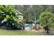 Lush backyard offers a kidney-shaped pool, patio with seating, and mature landscaping for a private oasis at 5640 Bella Terra Ct, Wake Forest, NC 27587