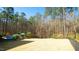 Large backyard featuring an inviting pool area, surrounded by a well-maintained lawn and mature trees at 5640 Bella Terra Ct, Wake Forest, NC 27587