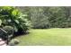 Well-manicured lawn is enhanced by mature landscaping and adds beauty to outdoor spaces at 5640 Bella Terra Ct, Wake Forest, NC 27587