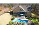 Aerial view of a home with outdoor seating area, lush landscaping, and a beautiful pool at 5640 Bella Terra Ct, Wake Forest, NC 27587