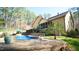 Relaxing backyard featuring a pool, deck with stairs and lush landscaping provides a luxurious outdoor experience at 5640 Bella Terra Ct, Wake Forest, NC 27587