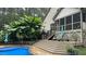Serene backyard showcasing a deck with stairs, screened-in porch, and patio with lounge chairs near pool at 5640 Bella Terra Ct, Wake Forest, NC 27587