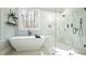 A modern bathroom features a standalone tub and glass enclosed shower with marble tile at 5640 Bella Terra Ct, Wake Forest, NC 27587