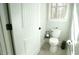 A half bathroom with a toilet, window and white painted door at 5640 Bella Terra Ct, Wake Forest, NC 27587
