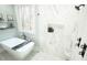 A modern bathroom features a standalone tub and glass enclosed shower with marble tile at 5640 Bella Terra Ct, Wake Forest, NC 27587