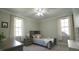 Cozy bedroom featuring a ceiling fan, two windows, and neutral paint throughout at 5640 Bella Terra Ct, Wake Forest, NC 27587