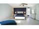 A spacious main bedroom with light wood floors, white trim, and blue accent wall at 5640 Bella Terra Ct, Wake Forest, NC 27587