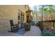 Charming deck with rocking chairs and a fire pit, offering a tranquil outdoor living space with views of the backyard at 5640 Bella Terra Ct, Wake Forest, NC 27587