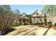 A well landscaped home with mature trees sits on a manicured lawn at 5640 Bella Terra Ct, Wake Forest, NC 27587