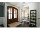 Elegant foyer with dark hardwood floors, double doors, and a view into a bright office space at 5640 Bella Terra Ct, Wake Forest, NC 27587