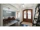 Elegant foyer with dark hardwood floors, an adjacent dining room, and a stunning wooden double door at 5640 Bella Terra Ct, Wake Forest, NC 27587