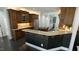 Well-equipped kitchen featuring dark wood cabinetry, granite countertops, and modern appliances at 5640 Bella Terra Ct, Wake Forest, NC 27587