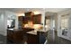 Eat in kitchen with dark wood cabinets, granite countertops and central island at 5640 Bella Terra Ct, Wake Forest, NC 27587