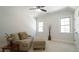 Living area with large windows, a neutral sofa and a ceiling fan at 5640 Bella Terra Ct, Wake Forest, NC 27587