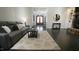 Cozy living room with hardwood floors, gray sofa, and entry to the home's front door at 5640 Bella Terra Ct, Wake Forest, NC 27587