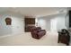 Open living room with a built-in wet bar, a leather recliner, and neutral carpet at 5640 Bella Terra Ct, Wake Forest, NC 27587