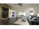 Bright living room features a stone fireplace, dark hardwood floors, and a gray sofa at 5640 Bella Terra Ct, Wake Forest, NC 27587