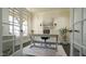 Bright and spacious home office with natural light, a classic rug, and access to the front porch at 5640 Bella Terra Ct, Wake Forest, NC 27587