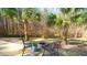 Cozy patio with a fire pit, comfortable seating, and palm trees, creating a relaxing outdoor retreat at 5640 Bella Terra Ct, Wake Forest, NC 27587