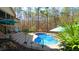Beautiful backyard with a pristine pool, complemented by lounge chairs and vibrant greenery, perfect for relaxation at 5640 Bella Terra Ct, Wake Forest, NC 27587