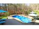 Stunning backyard pool area with a freeform pool, surrounded by lush landscaping and ample seating areas at 5640 Bella Terra Ct, Wake Forest, NC 27587