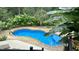 Aerial view of a kidney-shaped pool with lush landscaping and patio provides a secluded backyard escape at 5640 Bella Terra Ct, Wake Forest, NC 27587