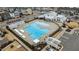 Aerial view of a community pool and clubhouse, surrounded by townhomes and parking spaces at 6351 Perry Creek Rd, Raleigh, NC 27616