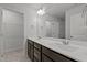 Spacious bathroom featuring double sinks with dark cabinets, ample counter space, and large mirror at 6351 Perry Creek Rd, Raleigh, NC 27616