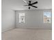 Large empty room with carpet, windows and ceiling fan at 6351 Perry Creek Rd, Raleigh, NC 27616