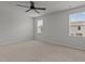 Large empty room with carpet, windows and ceiling fan at 6351 Perry Creek Rd, Raleigh, NC 27616