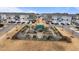 Aerial view of community garden with raised beds and a central green shaded area surrounded by townhomes at 6351 Perry Creek Rd, Raleigh, NC 27616
