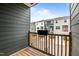 Cozy deck offers outdoor relaxation with views of neighboring townhomes and a wood railing at 6351 Perry Creek Rd, Raleigh, NC 27616