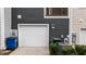 Attached garage with a white door, recycling and trash bins, and neat landscaping, adding curb appeal at 6351 Perry Creek Rd, Raleigh, NC 27616