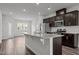 Open-concept kitchen featuring stainless steel appliances, granite countertops, and dark wood cabinets at 6351 Perry Creek Rd, Raleigh, NC 27616
