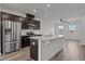 Modern kitchen boasts stainless steel appliances, granite countertops, and dark wood cabinetry at 6351 Perry Creek Rd, Raleigh, NC 27616