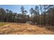 A cleared and graded lot with a home is set among wooded land ready for construction at 680 Jasmine Rd, Fuquay Varina, NC 27526